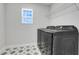 Clean laundry room with modern washer and dryer units, plus overhead shelving for storage at 678 Blackstone St, Minneola, FL 34715
