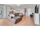 Spacious living room with hardwood floors that opens to the kitchen at 678 Blackstone St, Minneola, FL 34715