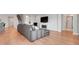 Open-concept living area with hardwood floors, fireplace and access to the kitchen at 678 Blackstone St, Minneola, FL 34715