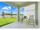 Inviting patio space with comfortable seating and a view of the green backyard under a sunny sky at 678 Blackstone St, Minneola, FL 34715