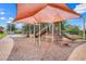 Community playground featuring a colorful play structure, shade cover, and soft ground covering at 678 Blackstone St, Minneola, FL 34715