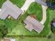 Overhead shot shows manicured lawns, mature trees, and home architecture in a residential area at 71 Stone Haven Ct, Leesburg, FL 34788