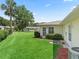 Expansive green backyard with a palm tree, well-maintained lawn, and mature shrubbery at 71 Stone Haven Ct, Leesburg, FL 34788