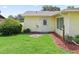 Well-maintained backyard with lush green lawn and a charming entrance to the home at 71 Stone Haven Ct, Leesburg, FL 34788