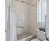 Clean bathroom featuring a shower with grab bar, toilet, and a small window for natural light at 71 Stone Haven Ct, Leesburg, FL 34788