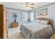 Serene bedroom with soft blue walls, a floral bedspread, and natural light creating a peaceful retreat at 71 Stone Haven Ct, Leesburg, FL 34788