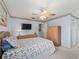 Cozy bedroom featuring light blue walls, a ceiling fan, and a wood dresser with a television at 71 Stone Haven Ct, Leesburg, FL 34788