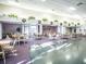 Multi-purpose clubhouse with tables, chairs, and decorative foliage at 71 Stone Haven Ct, Leesburg, FL 34788