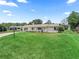 View of the home from the front yard; a single story home with great landscaping at 71 Stone Haven Ct, Leesburg, FL 34788