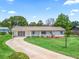 Charming single-story home with a well-manicured lawn, long driveway, and lovely curb appeal at 71 Stone Haven Ct, Leesburg, FL 34788