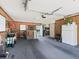 Garage interior featuring carpeted floor, wood paneling, and ample storage space at 71 Stone Haven Ct, Leesburg, FL 34788