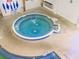 Relax in the indoor hot tub, featuring tile accents, stainless steel rails, and easy access steps at 71 Stone Haven Ct, Leesburg, FL 34788