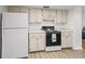 Functional kitchen area with white appliances, light-colored cabinetry, and ample counter space for meal preparation at 71 Stone Haven Ct, Leesburg, FL 34788