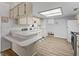 Well-lit kitchen with light-colored cabinets, laminate countertops, and modern appliances for a bright and functional cooking space at 71 Stone Haven Ct, Leesburg, FL 34788