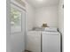 Functional laundry room with washer, dryer, and access to the backyard at 71 Stone Haven Ct, Leesburg, FL 34788