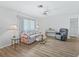 Living room with hard floors, ceiling fan, large windows, and a comfortable seating area at 71 Stone Haven Ct, Leesburg, FL 34788