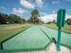 Outdoor recreational space featuring a green bocce ball court under a sunny sky at 71 Stone Haven Ct, Leesburg, FL 34788