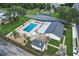 Aerial view of the community, showcasing the pool, clubhouse, and recreational facilities at 715 Surrey Pl, Leesburg, FL 34748