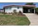 White home showing a carport, front yard, and easy access to outdoor activities at 715 Surrey Pl, Leesburg, FL 34748