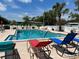 Community pool showcasing chairs, landscaped surroundings, and clear water at 715 Surrey Pl, Leesburg, FL 34748