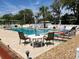 Relaxing community pool area with lounge chairs, umbrellas, and social gatherings at 715 Surrey Pl, Leesburg, FL 34748