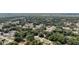 An aerial view shows a residential neighborhood with tree-lined streets and well-maintained homes at 8635 Se 156 St, Summerfield, FL 34491