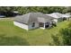 Aerial view showcases the spacious backyard with lush lawn and partial view of house at 8635 Se 156 St, Summerfield, FL 34491