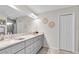 Bright bathroom with granite countertop vanity and large mirror at 8635 Se 156 St, Summerfield, FL 34491