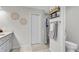 Bright bathroom features decorative wall art, granite vanity, and a tiled shower with a glass door at 8635 Se 156 St, Summerfield, FL 34491