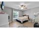 Cozy bedroom featuring modern vinyl flooring, a ceiling fan and natural lighting at 8635 Se 156 St, Summerfield, FL 34491