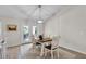 Cozy dining area with a modern light fixture and a view to the backyard at 8635 Se 156 St, Summerfield, FL 34491