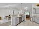 Open concept kitchen and living area with granite countertops and stainless steel dishwasher at 8635 Se 156 St, Summerfield, FL 34491