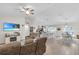 Spacious living room with vaulted ceiling open to the kitchen and dining area at 8635 Se 156 St, Summerfield, FL 34491