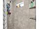 Walk-in shower featuring tiled walls with a showerhead, built-in shelves, and a modern shower curtain at 8635 Se 156 St, Summerfield, FL 34491