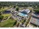 This aerial view features a community pool surrounded by golf cart parking, a clubhouse, and other amenities at 8738 Sw 95Th Ln # B, Ocala, FL 34481