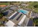 This aerial view shows a community pool, tennis courts, baseball field, and solar panels on the clubhouse roof at 8738 Sw 95Th Ln # B, Ocala, FL 34481