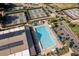 This aerial view shows a community pool, tennis courts, and solar panels on the clubhouse at 8738 Sw 95Th Ln # B, Ocala, FL 34481