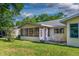 Backyard featuring a patio with outdoor seating and peaceful green space at 8738 Sw 95Th Ln # B, Ocala, FL 34481