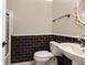 Charming bathroom with dark tile accent, elegant sink, and glass shower at 8738 Sw 95Th Ln # B, Ocala, FL 34481