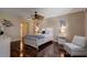 Cozy bedroom with hardwood floors, a ceiling fan, and tasteful decor at 8738 Sw 95Th Ln # B, Ocala, FL 34481