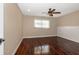 Bright bedroom features wood floors, ceiling fan, and a large window at 8738 Sw 95Th Ln # B, Ocala, FL 34481