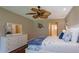 Comfortable bedroom with hardwood floors, a ceiling fan, dresser and view to bath at 8738 Sw 95Th Ln # B, Ocala, FL 34481