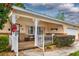 Charming front porch with decorative columns and a seating area, creating a welcoming and inviting entrance at 8738 Sw 95Th Ln # B, Ocala, FL 34481