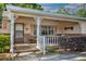 Inviting front porch, detailed columns, cozy seating area, and well-maintained landscaping at 8738 Sw 95Th Ln # B, Ocala, FL 34481