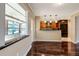 Bright kitchen with bar and view of breakfast nook with tile floors and wood cabinets at 8738 Sw 95Th Ln # B, Ocala, FL 34481