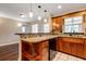 Inviting kitchen featuring granite counters, wood cabinets, and open to the living room at 8738 Sw 95Th Ln # B, Ocala, FL 34481