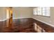 Well-lit living room with sleek wood floors and a bright window, offering a welcoming atmosphere at 8738 Sw 95Th Ln # B, Ocala, FL 34481