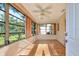 Bright sun room featuring tile flooring, multiple windows, and a ceiling fan, perfect for relaxation at 8738 Sw 95Th Ln # B, Ocala, FL 34481