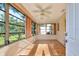 Breezy sunroom with tile flooring, ceiling fan, and windows bringing the beauty of nature indoors at 8738 Sw 95Th Ln # B, Ocala, FL 34481