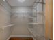 Spacious walk-in closet features wood floors and ample shelving for optimal organization at 8738 Sw 95Th Ln # B, Ocala, FL 34481